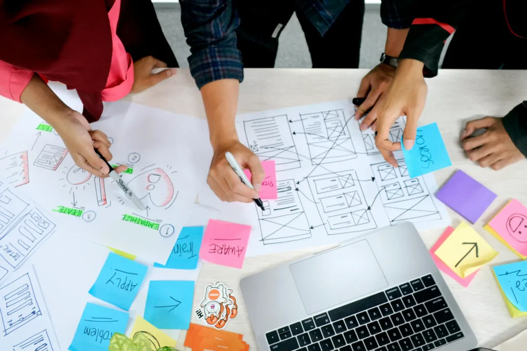Work planning with post its, mapping and a laptop